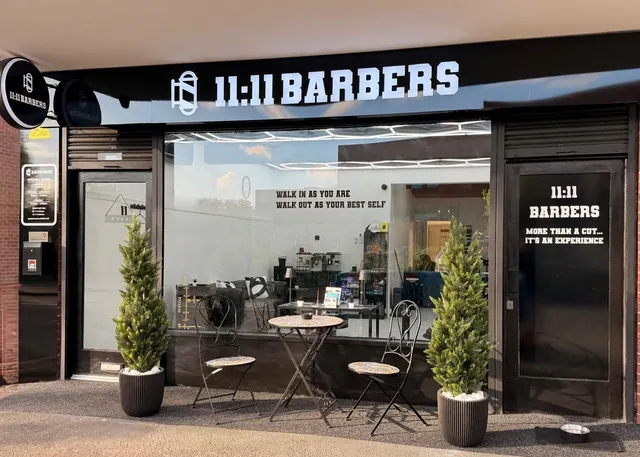 The 11:11 Barbers shopfront with its cafe tables outside