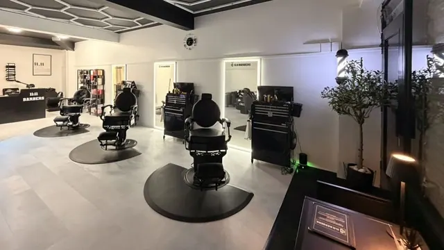 Inside 11:11 Barbers: the black chairs and white walls
